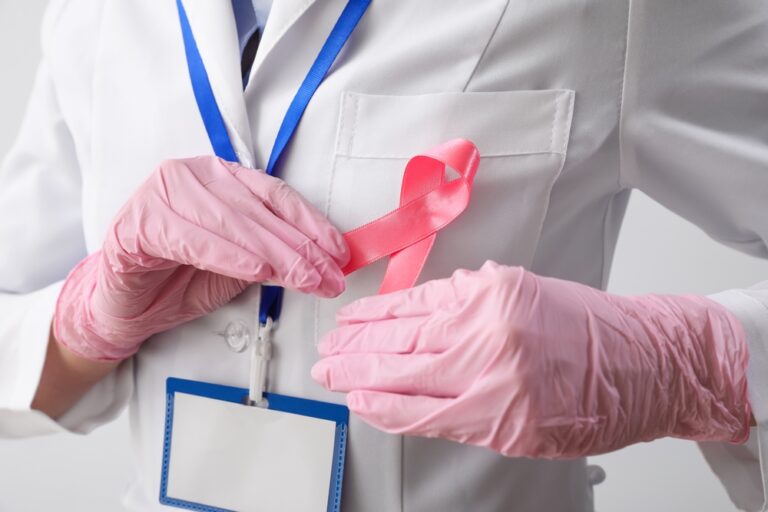 Female,Oncologist,With,Pink,Ribbon,On,Light,Background,,Closeup